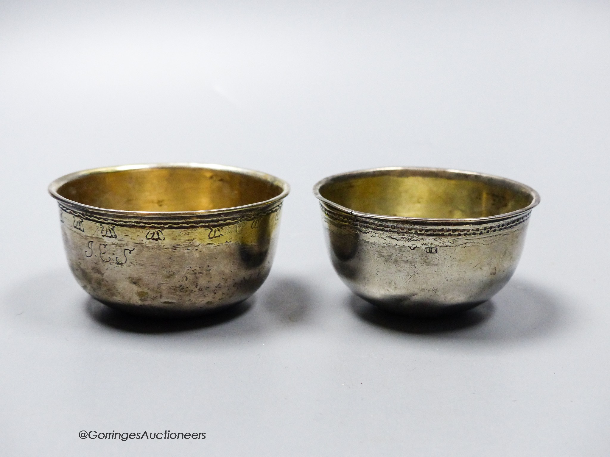 Two 18th century Swedish white metal small bowls, one with inset coin base dated 1708, height 31mm, gross 45 grams.